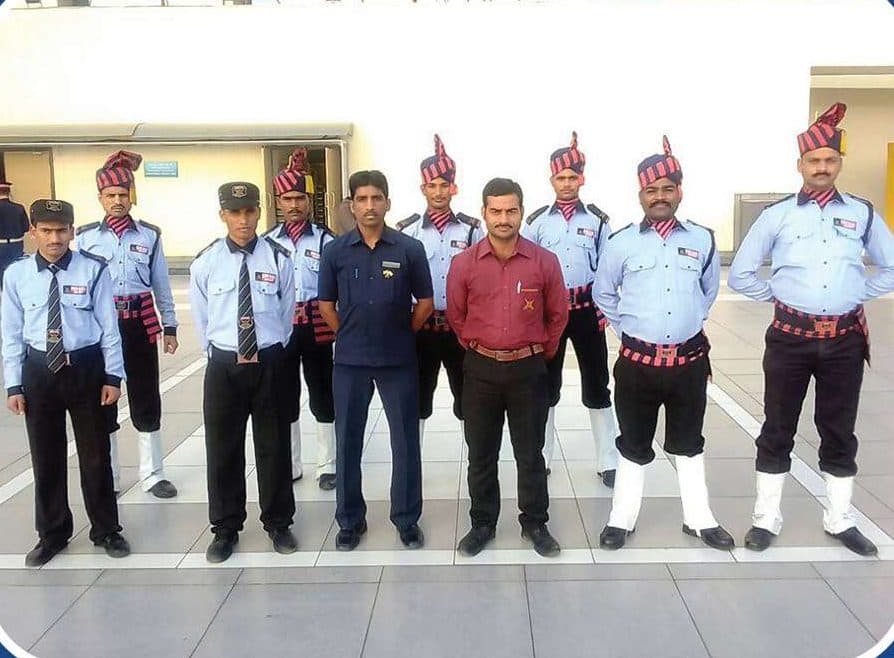 Om Sai security guards in ceremonial uniform